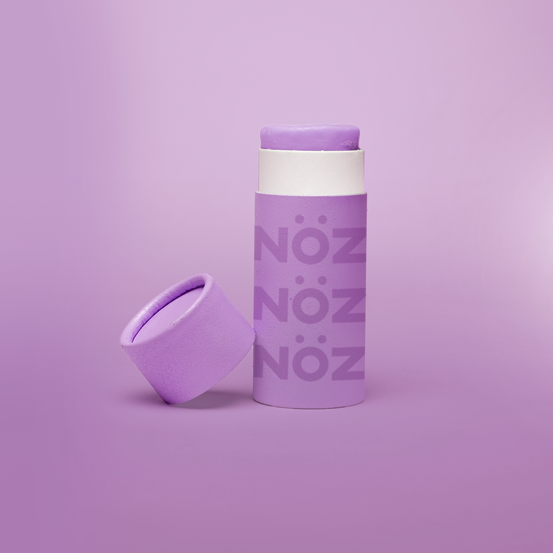 purple retractable sunscreen stick with the lid off